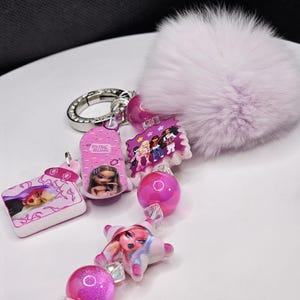 Doll themed keychain with purple pom and rhinestone key ring