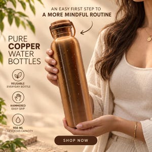 May include: A cylindrical copper water bottle with a metallic finish and a screw-top lid. The bottle features text stating PURE COPPER WATER BOTTLES, AN EASY FIRST STEP TO A MORE MINDFUL ROUTINE, REUSABLE EVERYDAY BOTTLE, HAMMERED EASY GRIP, and 950 ML.