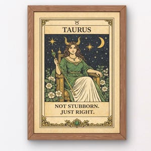 Peut inclure: Une affiche encadrée avec une illustration vintage du signe du zodiaque du Taureau. Elle représente une femme en robe verte sur un trône, avec le texte « NOT STUBBORN. JUST RIGHT. » Le cadre est de couleur marron chaud.