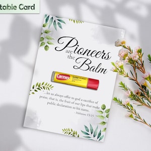 May include: A printable card with the text "Pioneers are the Balm" and a Carmex lip balm. The card is decorated with green leaves and a quote from Hebrews 13:15. The background is white with a floral arrangement.