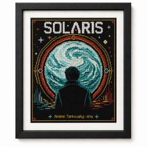 May include: A framed cross-stitch embroidery featuring the title SOLARIS in white block letters. A central circular blue and white swirling planet is viewed by a dark silhouette of a person. The text Andrei Tarkousky - 1972 appears at the bottom.