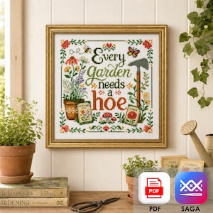 May include: A framed cross-stitch sampler featuring the text Every Garden needs a hoe in green and orange lettering. The design includes a potted plant, a garden hoe, a butterfly, a bee, mushrooms, and two seed packets labeled Wildflower Mix and Zinnia.