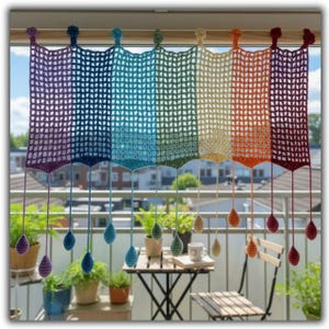 May include: A rainbow-colored, crocheted window curtain. The curtain is made of open-weave squares and hangs from a rod. Each section of the curtain is a different color, including purple, blue, green, yellow, orange, and red. The curtain has dangling teardrop-shaped ornaments.