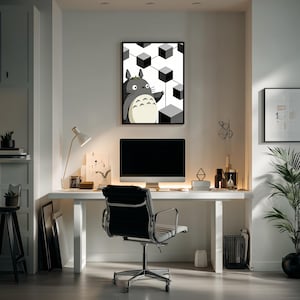 May include: A framed wall art print featuring a grey, round-bodied creature with pointed ears and a cream-coloured belly with chevron markings, standing against a background of floating black and white cubes in a geometric pattern.