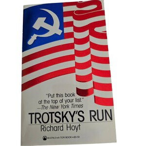 May include: A paperback book titled Trotsky's Run by Richard Hoyt. The cover features a stylized American flag with a white hammer and sickle symbol in the blue field. Text includes a New York Times quote, the title, author, and publisher info.