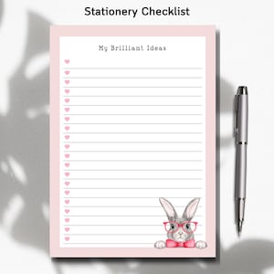 May include: A pink stationery checklist with the text "Stationery Checklist" and "My Brilliant Ideas". The checklist has a bunny illustration wearing glasses and a bow tie. A silver pen is placed next to the checklist.