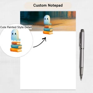 May include: A white notepad with a header featuring a small white ghost hovering above a stack of three books in orange and blue. A silver pen is positioned to the right of the notepad. The text Custom Notepad appears at the top center.
