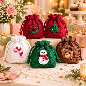 May include: Five small drawstring pouches made of crocheted yarn. Two are red with a green wreath and a green Christmas tree, one is white with a candy cane, one is green with a snowman, and one is brown with a teddy bear face applique.
