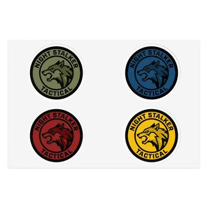 May include: Four circular stickers with the text "NIGHT STALKER TACTICAL" around a wolf head graphic. The stickers are in olive green, navy blue, red, and yellow with white and black details.