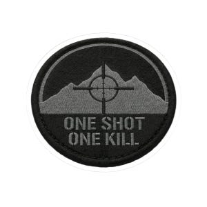 May include: A circular patch with a black border and background. The patch features a gray mountain range with a crosshair target in the center. Below the mountains, the text "ONE SHOT ONE KILL" is embroidered in white.