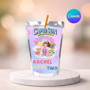 May include: Capri Sun juice pouch with a straw. The pouch features a colorful design with the text "Capri Sun All Natural". The design includes a cartoon girl, a rainbow, and the text "Rachel is turning TWO".