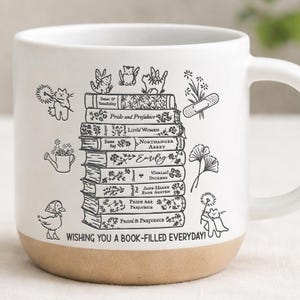 May include: White ceramic mug with a tan base, featuring a stack of illustrated books with titles like "Pride and Prejudice" and "Little Women." The mug is decorated with whimsical drawings and the text "Wishing you a book-filled everyday!"