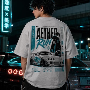 May include: A grey t-shirt with a graphic design. The design includes the text "Aether Run", a sports car illustration, and Japanese text. The graphic elements are in teal and black.