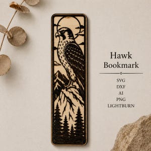 May include: A rectangular wooden bookmark featuring a laser-engraved design of a hawk perched on a mountain peak above a forest, with a sun and clouds in the background. The text "Hawk Bookmark" is printed alongside the file formats SVG, DXF, AI, PNG, LIGHTBURN.