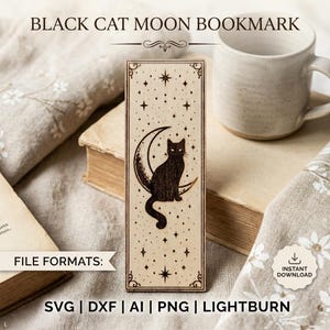 May include: A wooden bookmark featuring a black cat sitting on a crescent moon, surrounded by stars. The bookmark has a decorative border and the text "BLACK CAT MOON BOOKMARK" at the top. The image also includes a mug and a book.