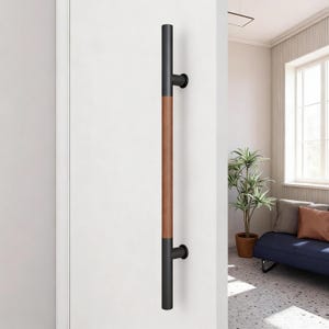 May include: A white ceramic mug with a black handle and the text "But First, Coffee" in a handwritten style. The mug is on a white surface. The mug is approximately 10 cm tall.