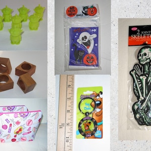 May include: Assortment of Halloween themed items including green alien figurines, wooden napkin rings, a Scooby Doo key chain, a package of 40 trick or treat bags, a package of two jointed skeletons, and two pink and white makeup bags.