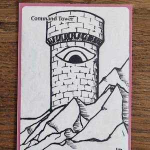 May include: A hand-drawn card with a pink border features a black and white illustration of a tower with an eye, labeled "Command Tower." The tower is atop a mountain range.