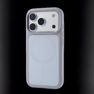 May include: A light gray phone case with a camera module featuring three black lenses and a small circular lens. The case has a light blue back with a circular design, and a gray frame. The phone case is designed to protect the phone.