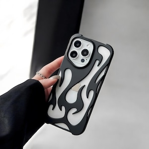 May include: Black and white flame design phone case. The case has a black border with a white flame pattern. The phone case has a camera cutout and a silver camera lens.