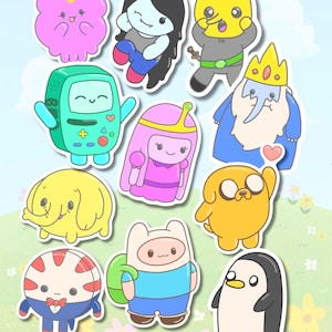 Puede incluir: Una colección de once pegatinas de personajes de dibujos animados coloridos que incluyen una nube rosa, una figura de pelo negro, un personaje amarillo con cabeza de limón, una consola de juegos verde, una princesa de pelo rosa, un rey azul, un elefante amarillo, un perro amarillo, un caramelo de menta, un niño con mochila verde y un pingüino blanco y negro.
