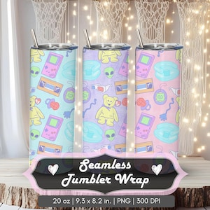 May include: Three 20 oz tumblers with a seamless pattern of retro toys, aliens, and teddy bears in pastel colors. Each tumbler has a silver straw and a matching lid. The image includes the text "Seamless Tumbler Wrap".