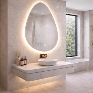 May include: Contemporary bathroom featuring an oval mirror with a glowing edge, displaying the time. A white sink is set on a floating vanity with a marble surface. The room has neutral walls and flooring, creating a minimalist design.