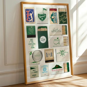 May include: A framed collection of vintage matchbooks, primarily green and white, with golf-themed designs and text. The frame is a light wood color, and the matchbooks are arranged in a grid pattern. The image is well-lit, with shadows adding depth.