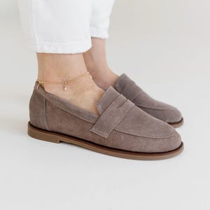 Bottom view of handcrafted suede loafers with a durable yet thin non-slip sole, indicating artisan quality.