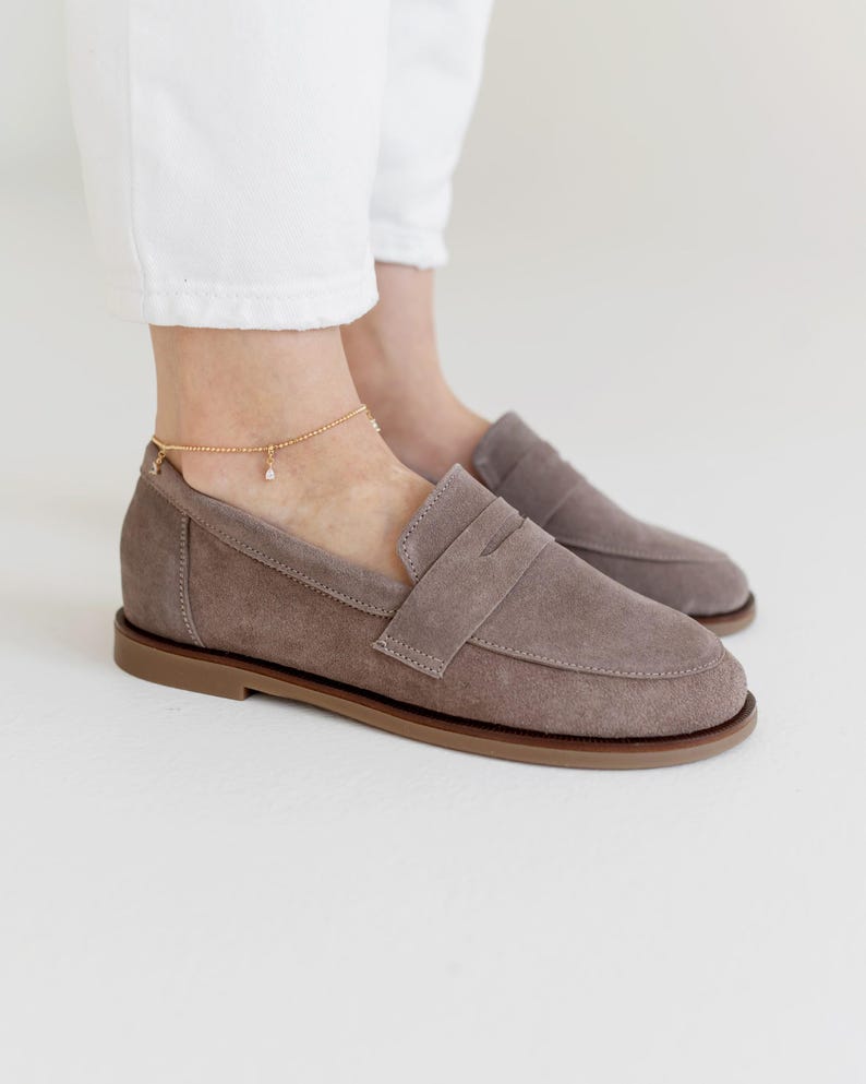 Bottom view of handcrafted suede loafers with a durable yet thin non-slip sole, indicating artisan quality.