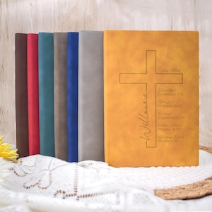 May include: A selection of journals in various colours, with a mustard-yellow cover featuring a cross design and the text "You Are Beautiful, Strong, Enough, Never Alone, Always Loved" and the name "Willowree".
