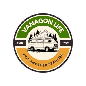 May include: Circular sticker with a cream-colored van illustration, mountains, and pine trees. The text "VANAGON LIFE" arches across the top in green, with "NOT ANOTHER SPRINTER" at the bottom. The sticker also includes "ESTD 1979".