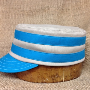 Cumberlanders Vintage Base Ball cap. Khaki bull denim cap with teal short visor and bands, Cotton sweatband, fitted to any size.