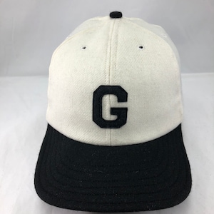 White wool flannel 6 panel cap,  black 2 1/2 in. visor. Hand cut Black G felt logo. Custom hat, Made to order, fitted, any size available.