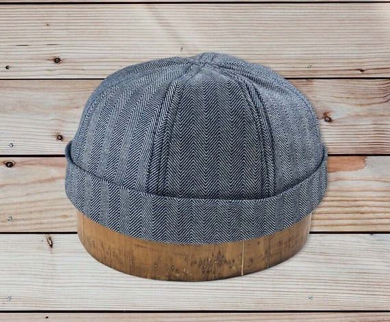 Docker 8 panel cap. Cotton denim in herringbone or hickory stripe, folded cuff, fitted to any size.