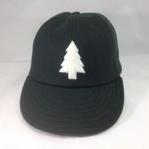 Felt Pine tree logo on wool flannel cap. Chose cap color and size at checkout! Hand crafted to order.