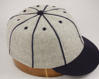Light Grey Melton wool 8 panel baseball cap with navy soutache, eyelets, 2 inch visor, shallow vintage cut, fitted to any size.