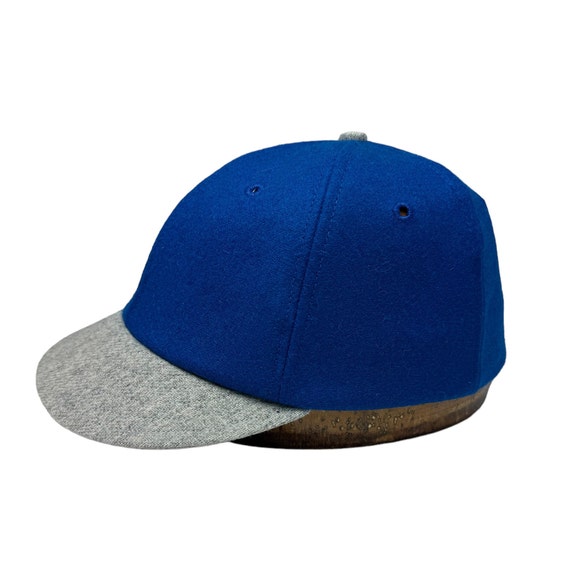 Royal blue melton wool 6 panel cap with light grey visor available in various lengths. Any size, custom made to order