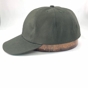 May include: A dark green baseball cap with a curved brim.