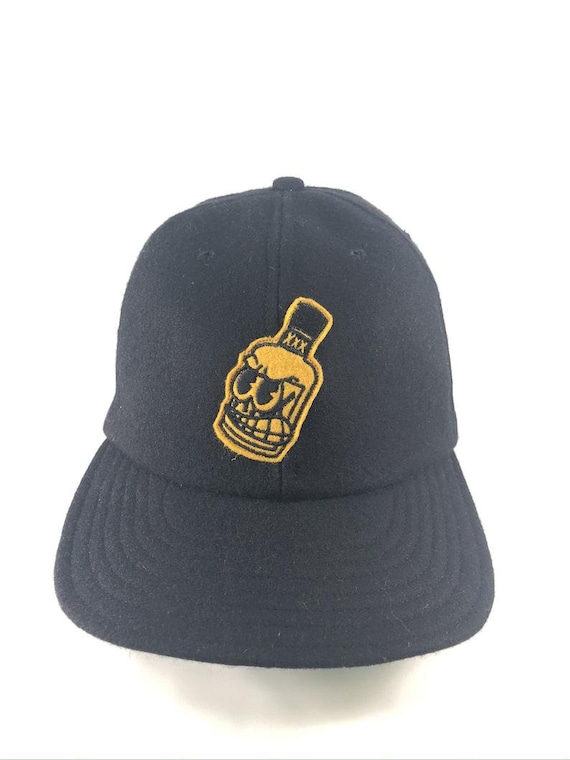 Whiskey Bottle - By Russell Balliet - Black melton wool 6 panel cap with flexible visor and wool felt embroidered patch. Any size available.