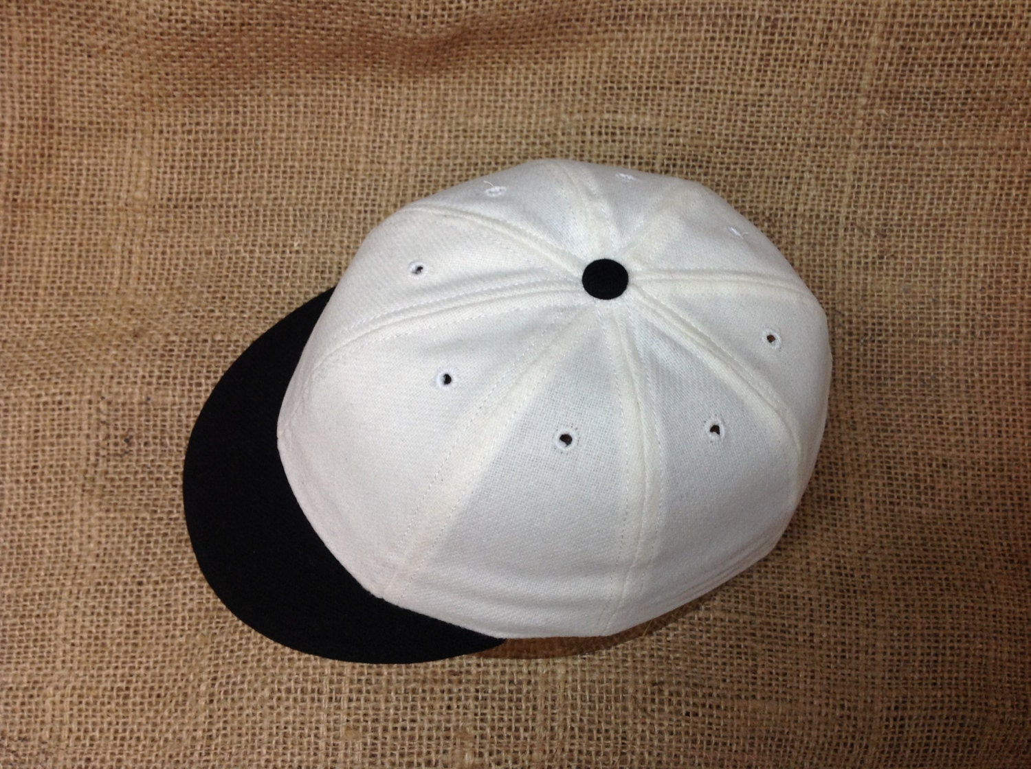 White wool flannel 8 panel cap with black 1910 visor. Fitted to any size.