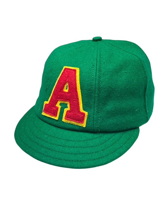 The Angus Schoolboy cap. Wool 6 panel with short 1.5” visor, fitted to any size. Wool felt two layer logo stitched onto front.