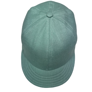 May include: A green, fabric baseball cap with a curved brim.
