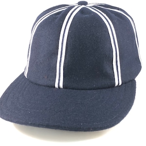 Navy wool 8 panel cap with white and navy braid trim on seams. Leather sweatband, any size. Vintage shallow design cap. 2 1/2" inch visor.