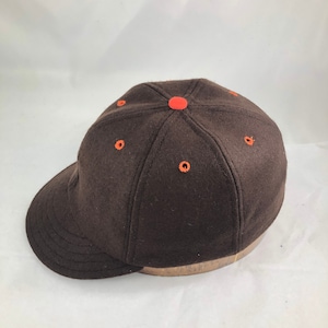 Pick Out Your Accent Colors -  On our 6 panel brown melton wool cap with contrasting accent color eyelets and button.