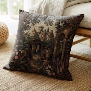 May include: A square throw pillow featuring a detailed tapestry-style print of a stone castle surrounded by lush gardens, trees, and flowers. The scene includes architectural arches, a white bird in flight, and a path leading to the castle entrance.