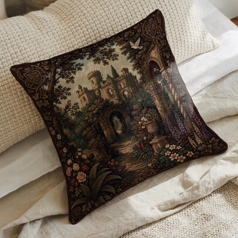 May include: A square throw pillow featuring a detailed tapestry-style print of a stone castle surrounded by lush trees, garden arches, and blooming flowers in shades of brown, green, and purple, with a small white bird flying in the sky.