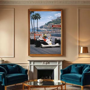 May include: Framed print of a Formula 1 race car speeding on a track. The car is white, red, and black, with the "Marlboro" logo visible. The background shows a coastal city with palm trees and a sign that reads "Monaco".