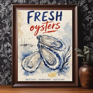 May include: A framed print with the words "FRESH oysters" in blue and red watercolor lettering. The image features three oysters, a lemon slice, and a watercolor depiction of a seascape with sailboats. The text "BRITTANY • NORMANDY • AQUITAINE" is at the bottom.