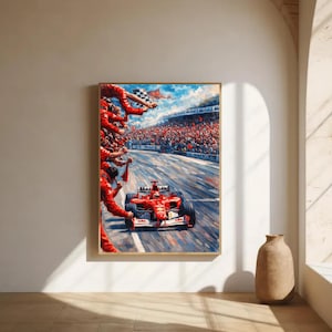 Könnte beinhalten: Gerahmtes Gemälde eines roten Formel-1-Rennwagens, der die Ziellinie überquert. Zuschauer in roten Uniformen und eine Menge auf der Tribüne feiern den Sieg. Das Kunstwerk ist vor blauem Himmel angesiedelt.